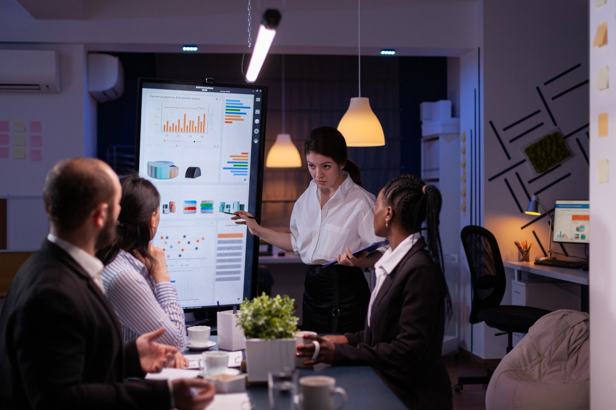 Team member presenting a digital strategy on a big screen during a meeting, with colleagues engaged in the discussion.